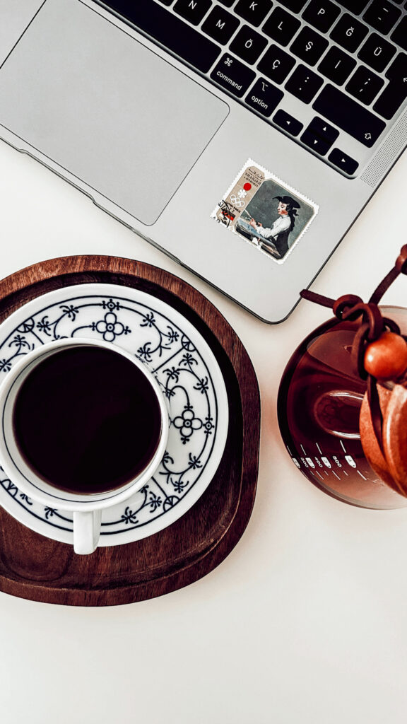 What Causes Extreme Mid-Afternoon Fatigue (Why You Crash Hard Around 2–4 PM) | photo representing extreme mid-afternoon fatigue with a laptop and coffee